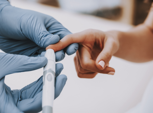 person with diabetes pricking finger to check blood sugar